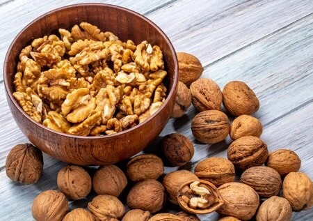 A group of walnut halves rich in healthy fats.