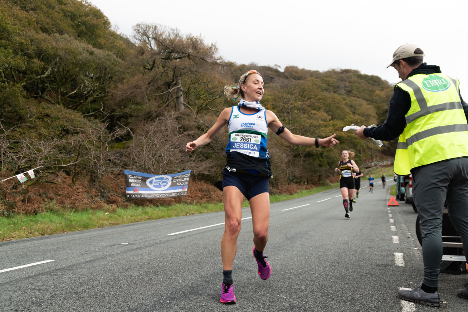 A competitive group of marathon runners running together on a city street.