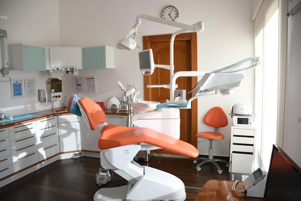 A senior patient smiling during a dental examination with a dentist.