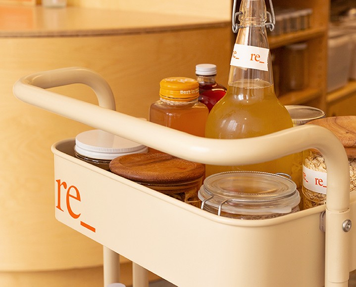 Glass jars filled with powders like beet root and collagen with clean labels.