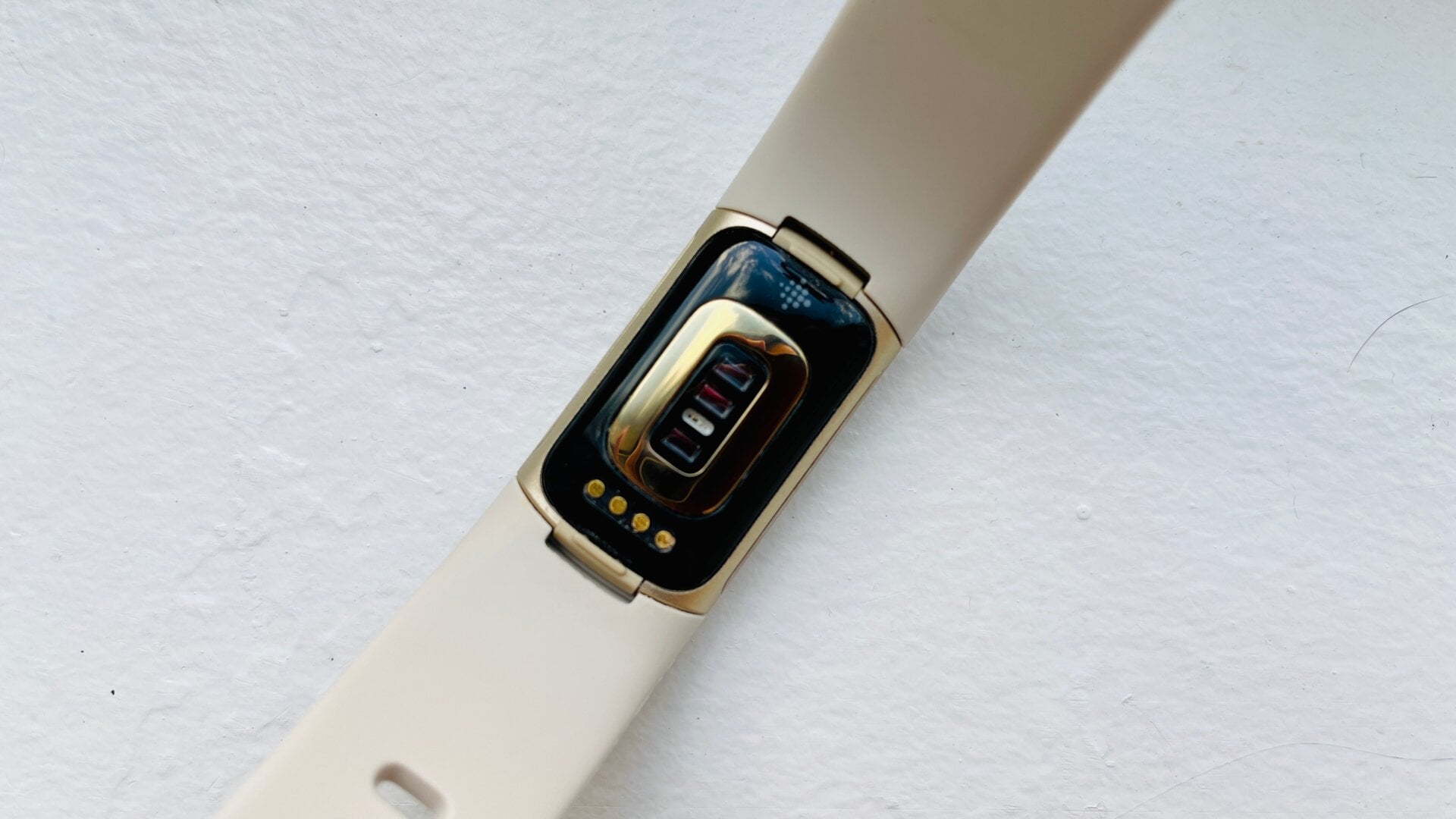 Side profile of the Fitbit Charge 5 highlighting the metal sensor strips.