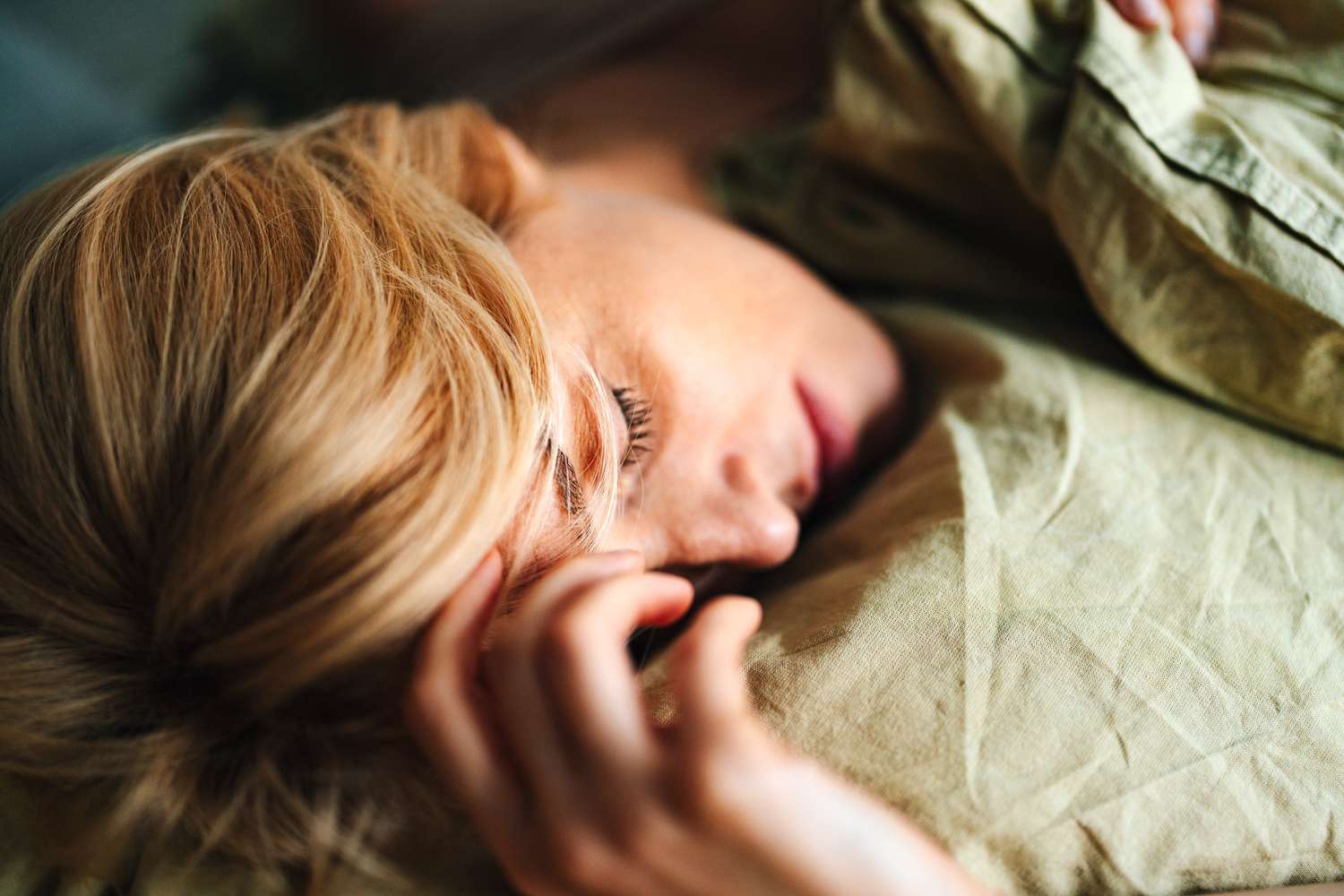 A woman sleeping deeply without the disruption of snoring or breathing interruptions.