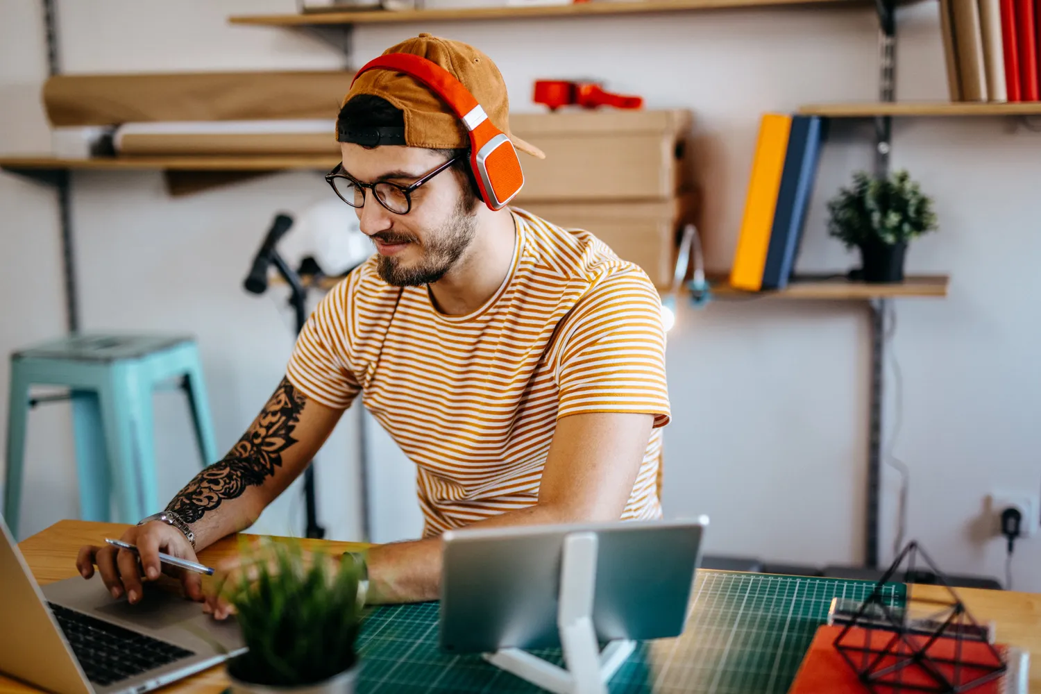 A young man sitting at an office desk looking tired and overwhelmed, representing common symptoms of thyroid dysfunction.