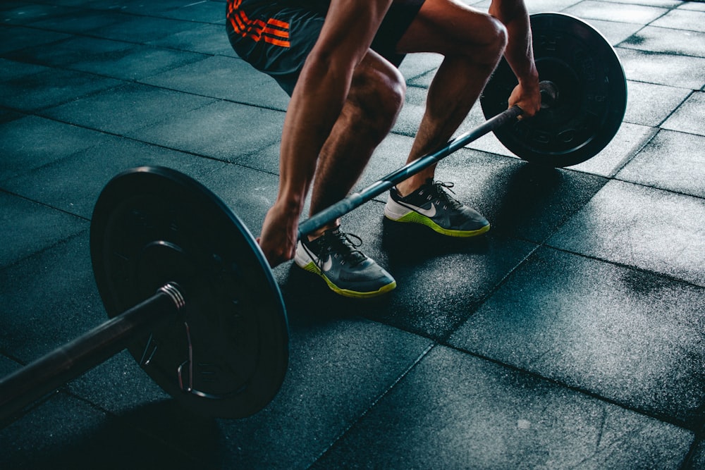 A clean, sanitized gym facility featuring wrestling mats and training equipment.