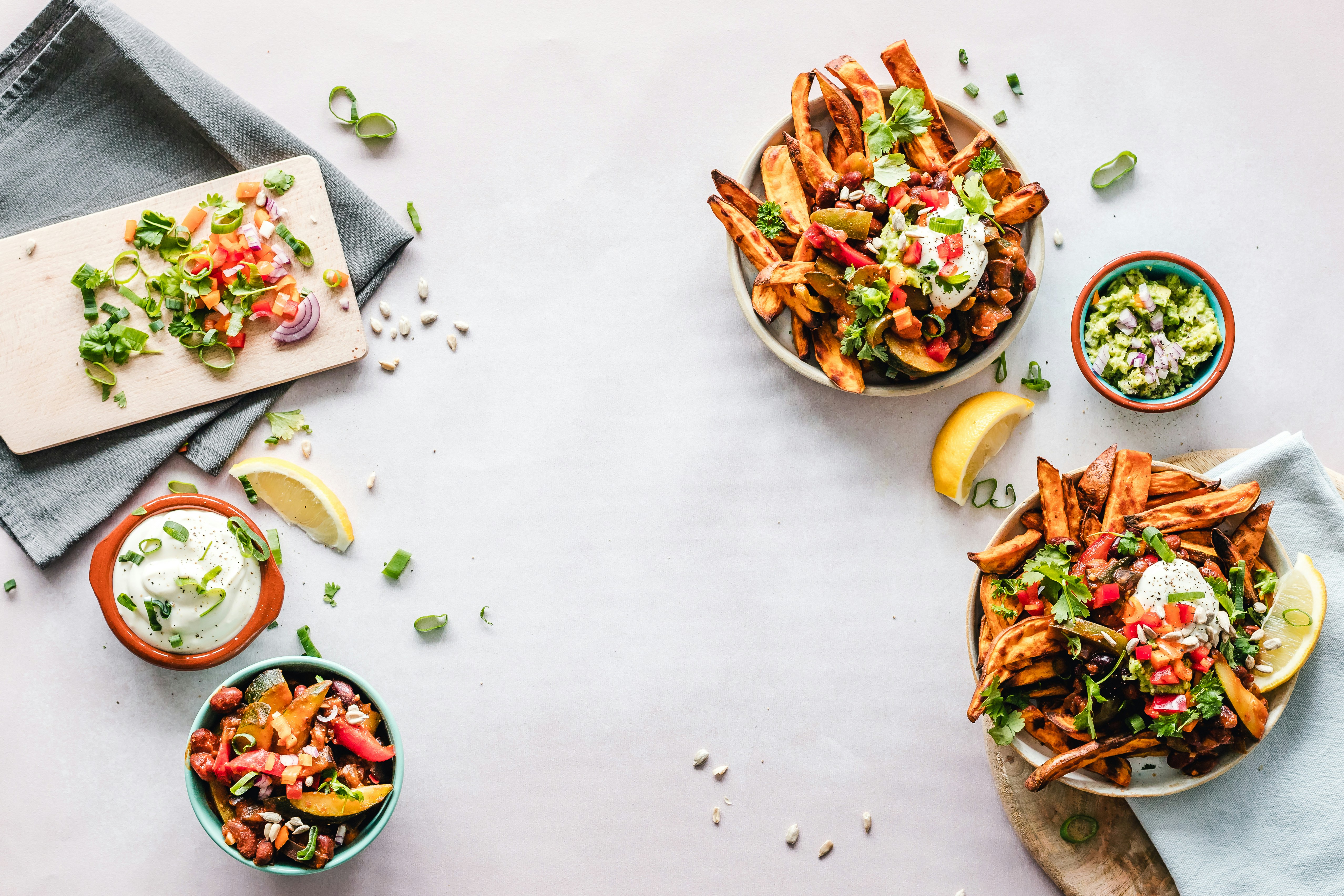 Multiple meal prep containers filled with roasted vegetables and protein sources.