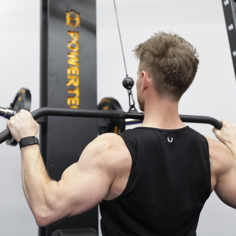 A wide-grip lat pulldown being performed on a cable machine.