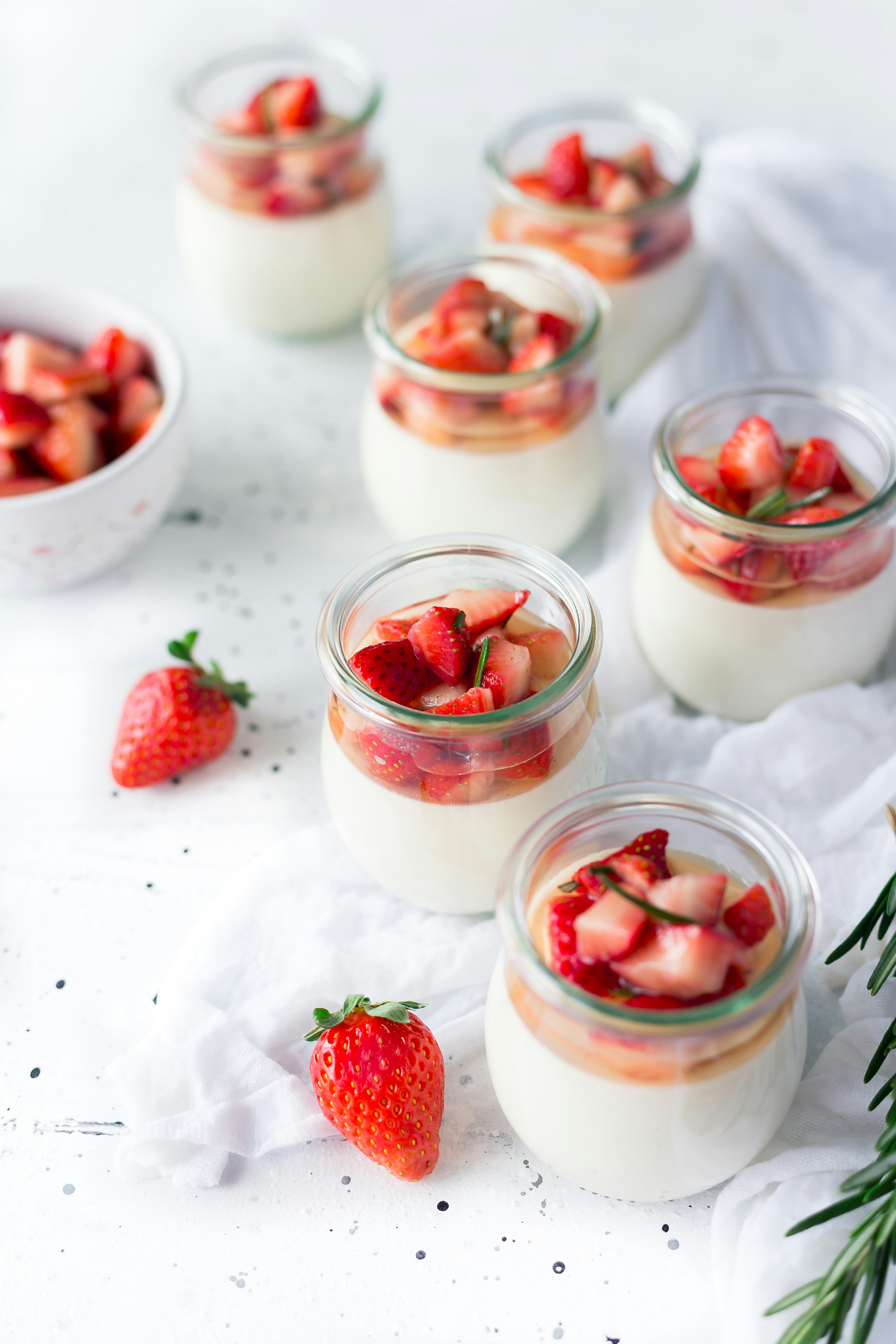 A bowl of Greek yogurt topped with fresh fruit and nuts.