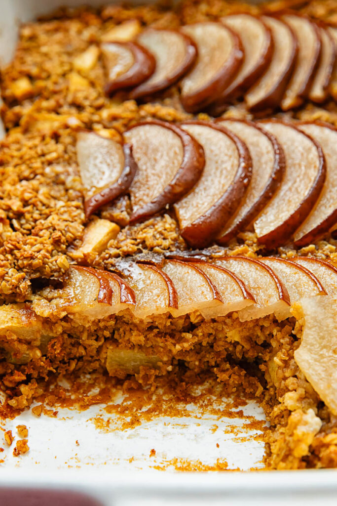 A detailed close-up showing the soft, caramelized texture of sliced pears embedded in a base of thick rolled oats.