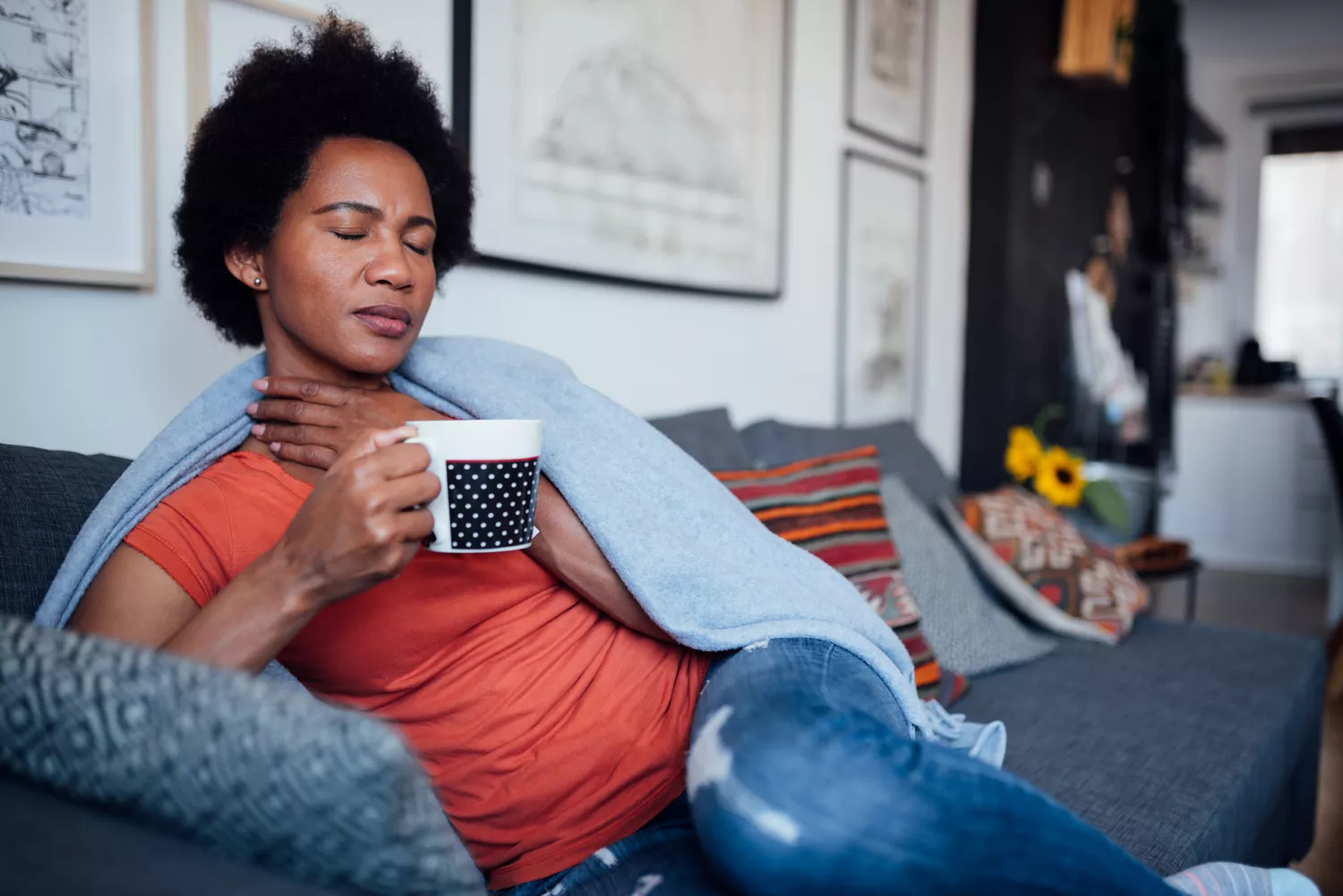 A person at home resting, reflecting the physical reality of managing medication-related discomfort.
