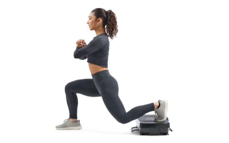 A person performing a lunge with one foot on a vibration platform.
