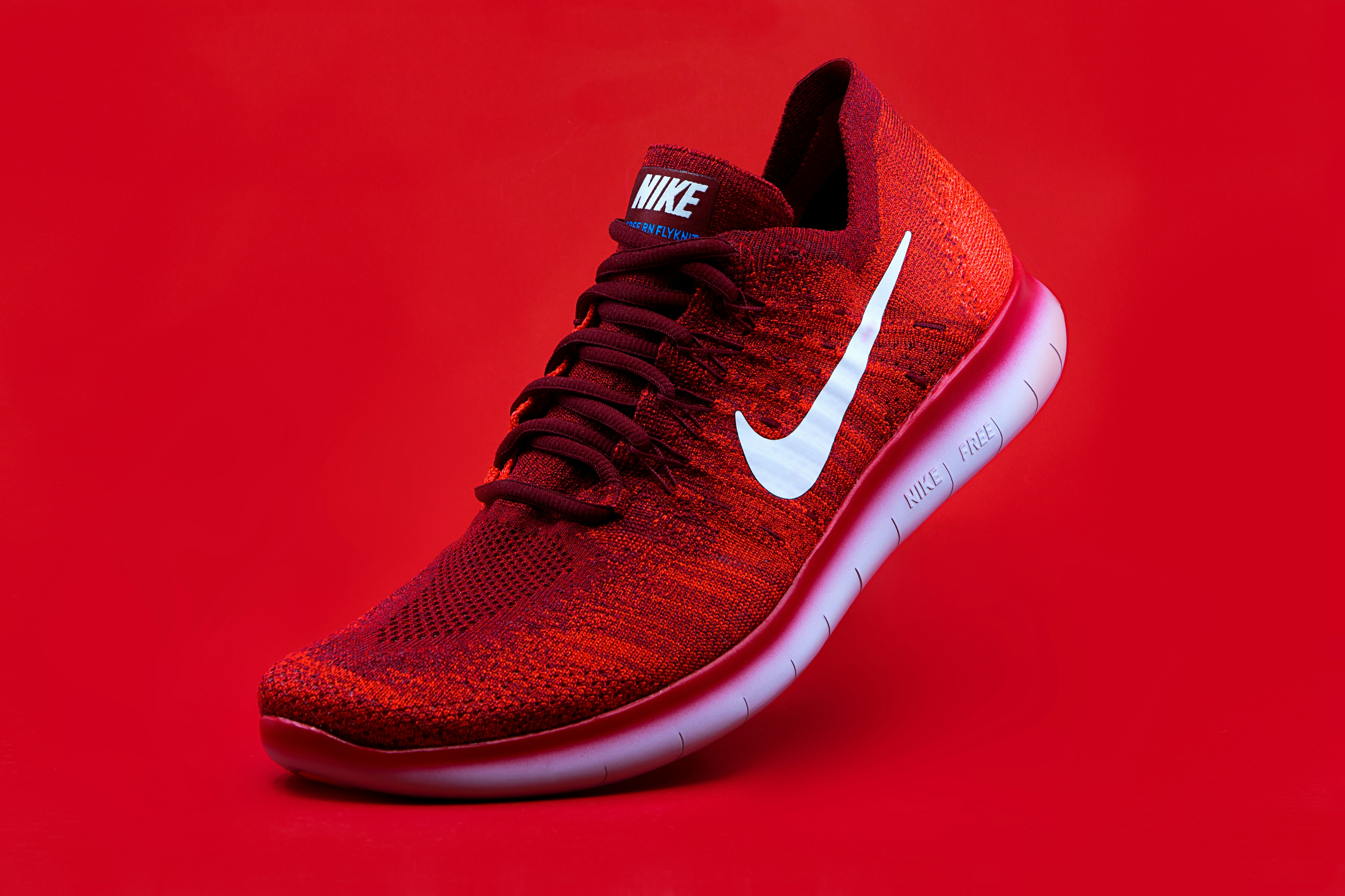 A pair of modern running shoes on a paved walking trail.