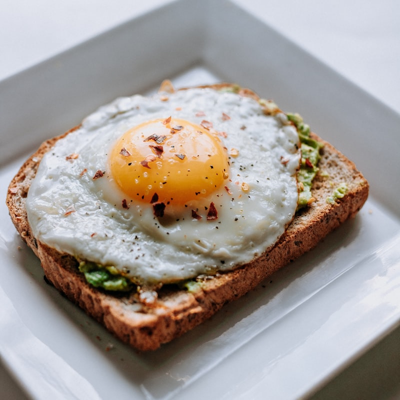 Soft scrambled eggs served on a white plate.