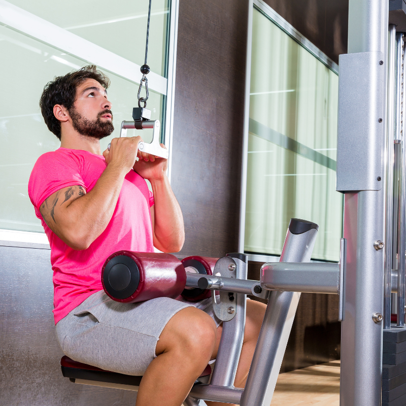 An athlete performing a close-grip lat pulldown variation.