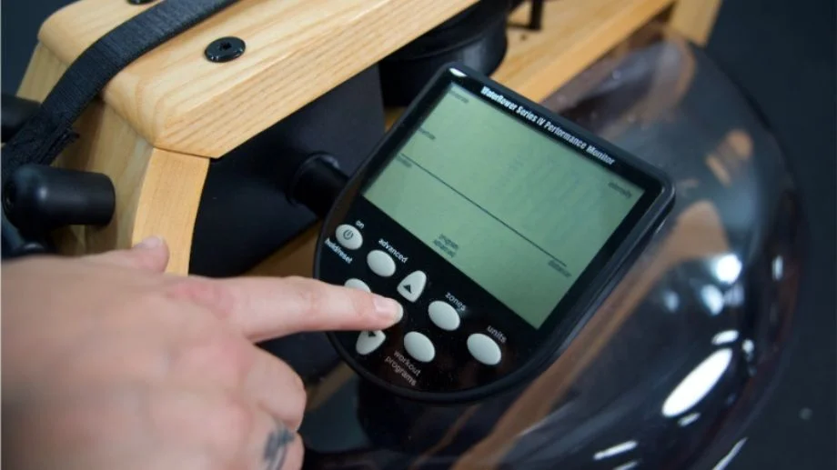 The S4 performance monitor mounted on a wooden rower showing digital metrics.