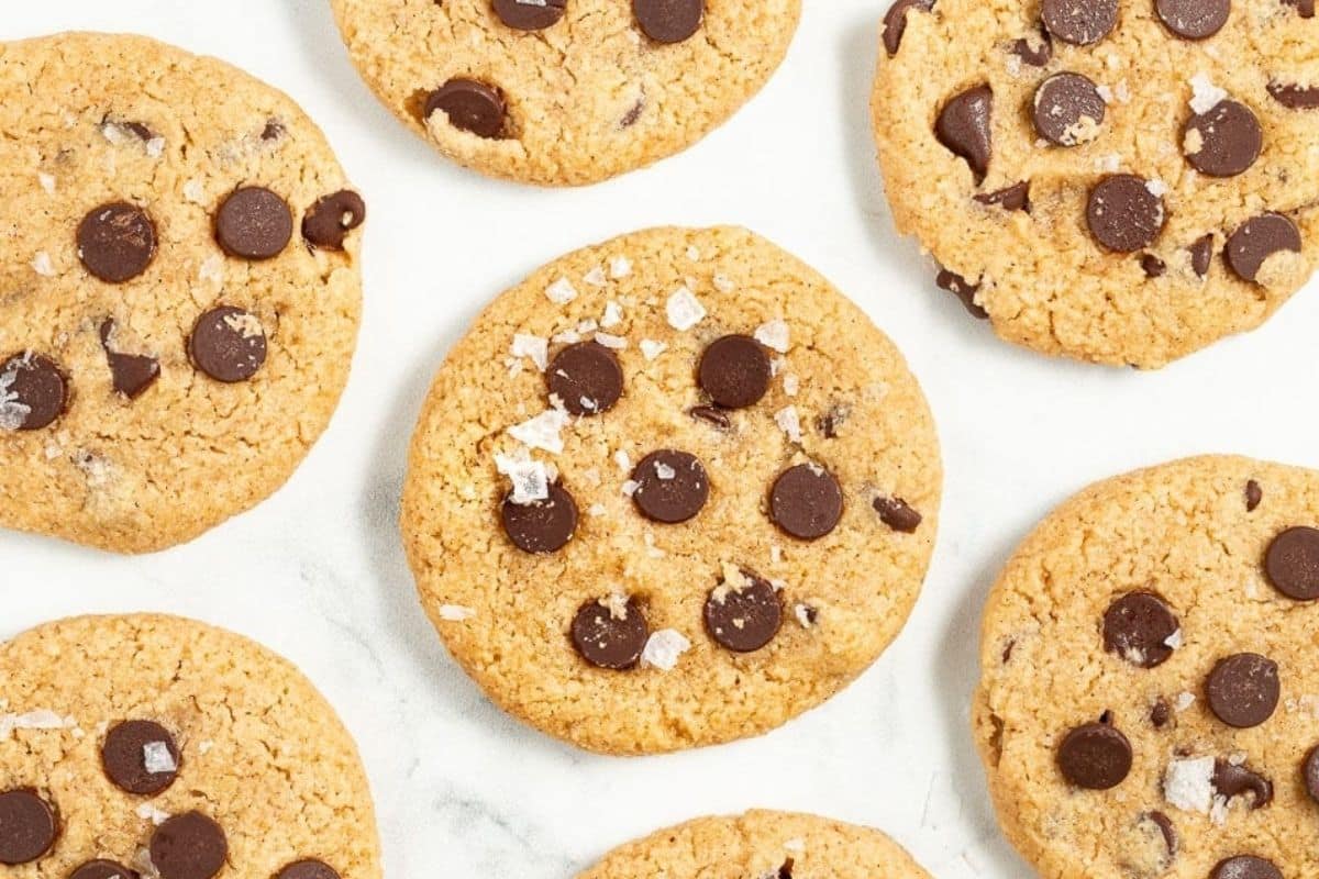 Freshly baked cookies cooling on a wire rack over a baking sheet.