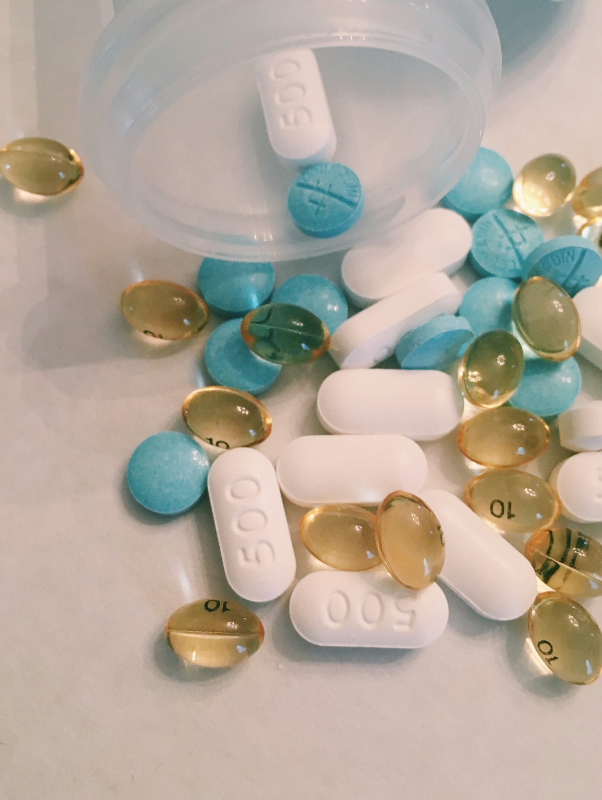 Close-up view of various nutritional supplement capsules and tablets in different colors and shapes.