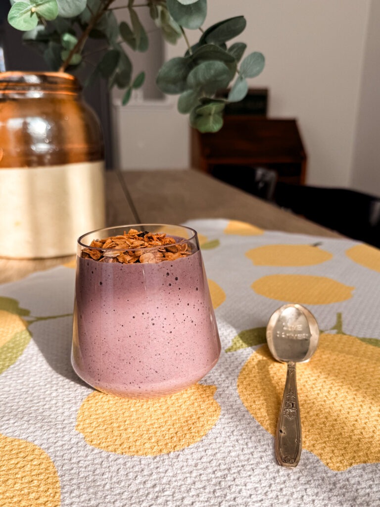 An array of smoothie ingredients including chia seeds, berries, and oats laid out on a table.