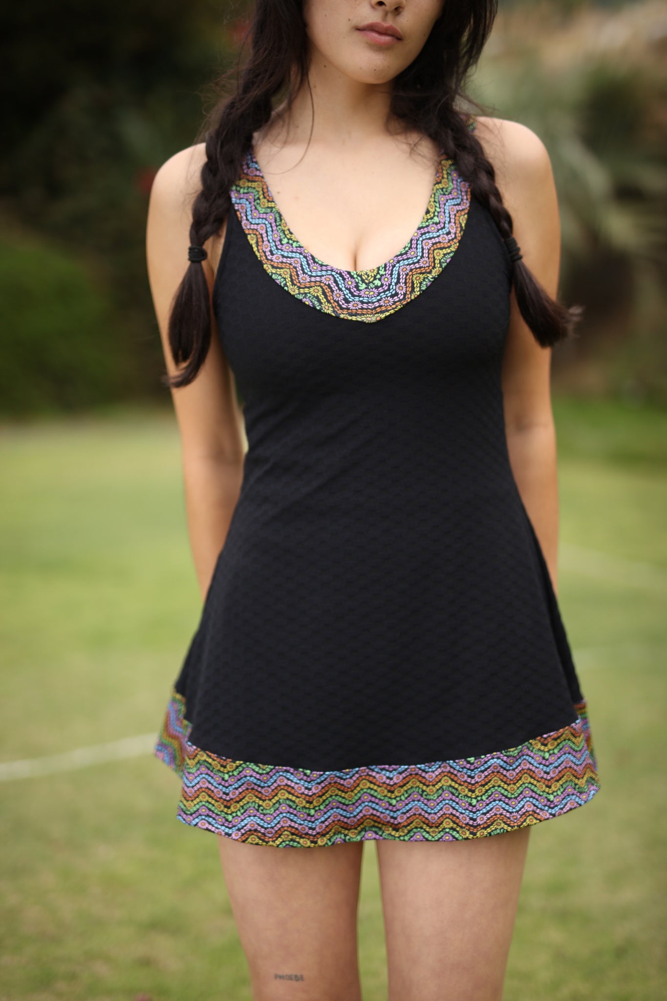 A black recycled active dress with rainbow trim by Laurel Canyon Tennis Club.