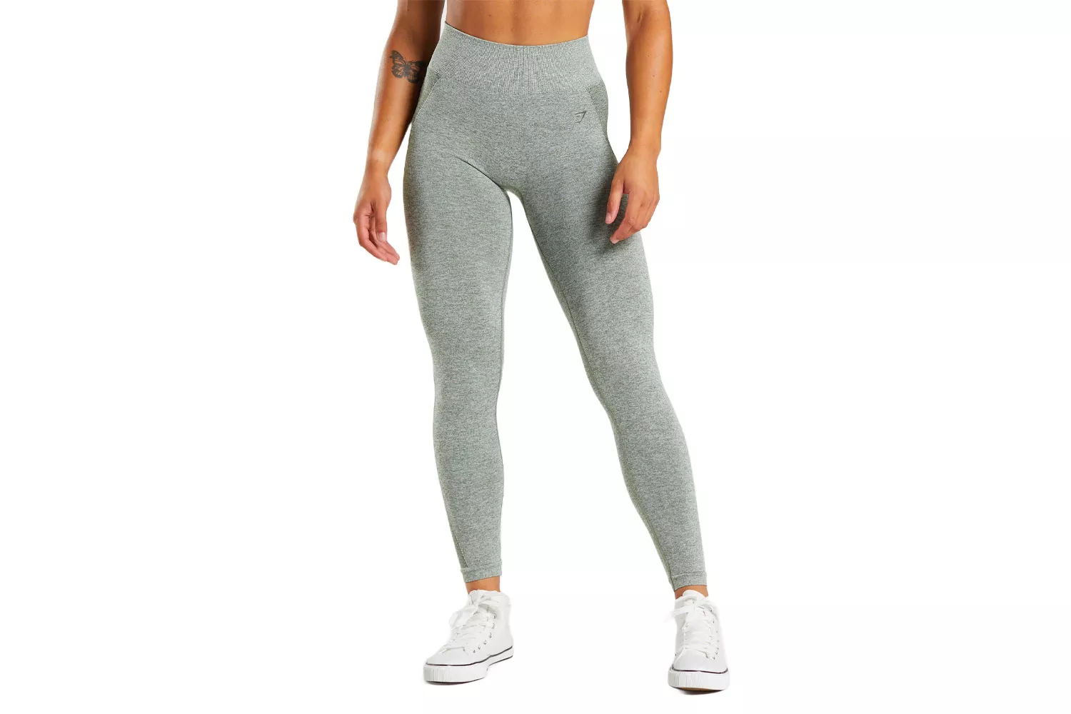 A woman modeling gray high-waisted Gymshark leggings with a ribbed waistband.