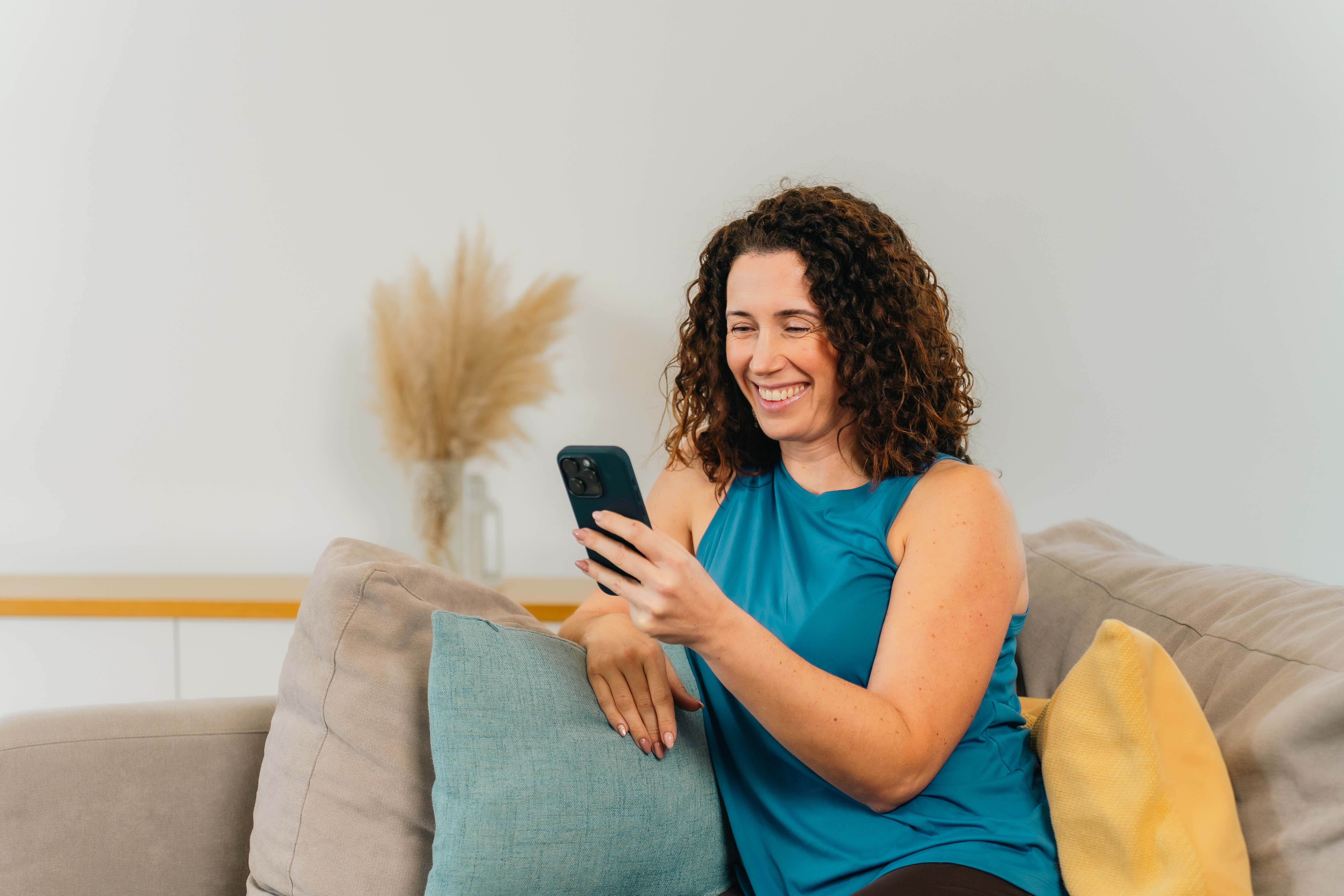 A hand holding a smartphone showing a connection to a health specialist.
