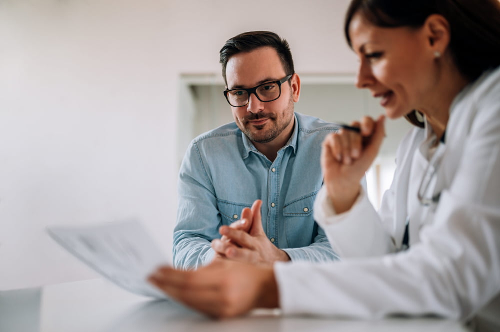A healthcare professional consulting with a patient about hearing loss solutions.