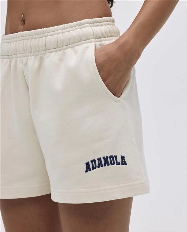 A woman wearing a modern athletic tennis outfit styled for a casual lookbook.