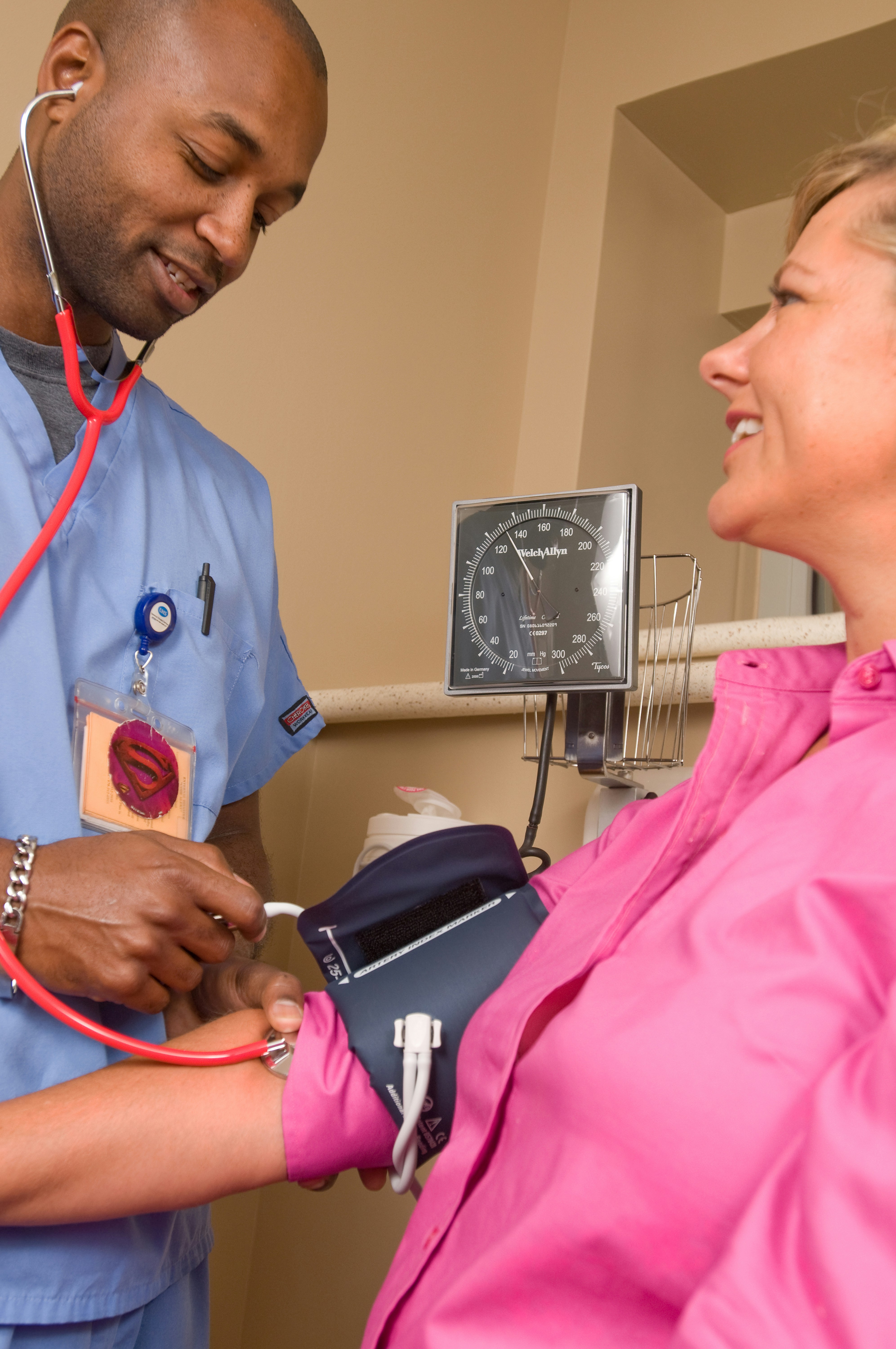 A close-up of a modern automated insulin delivery system sensor attached to a patient's arm.