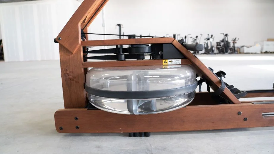 A detailed close-up of the clear water tank and internal paddles of the Ergatta rower.