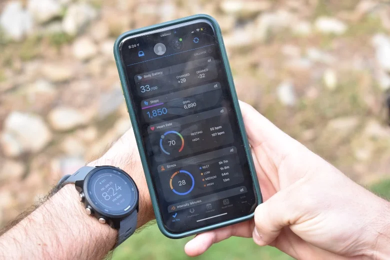 A smartphone showing the Garmin Connect app interface with Body Battery and sleep tracking statistics.