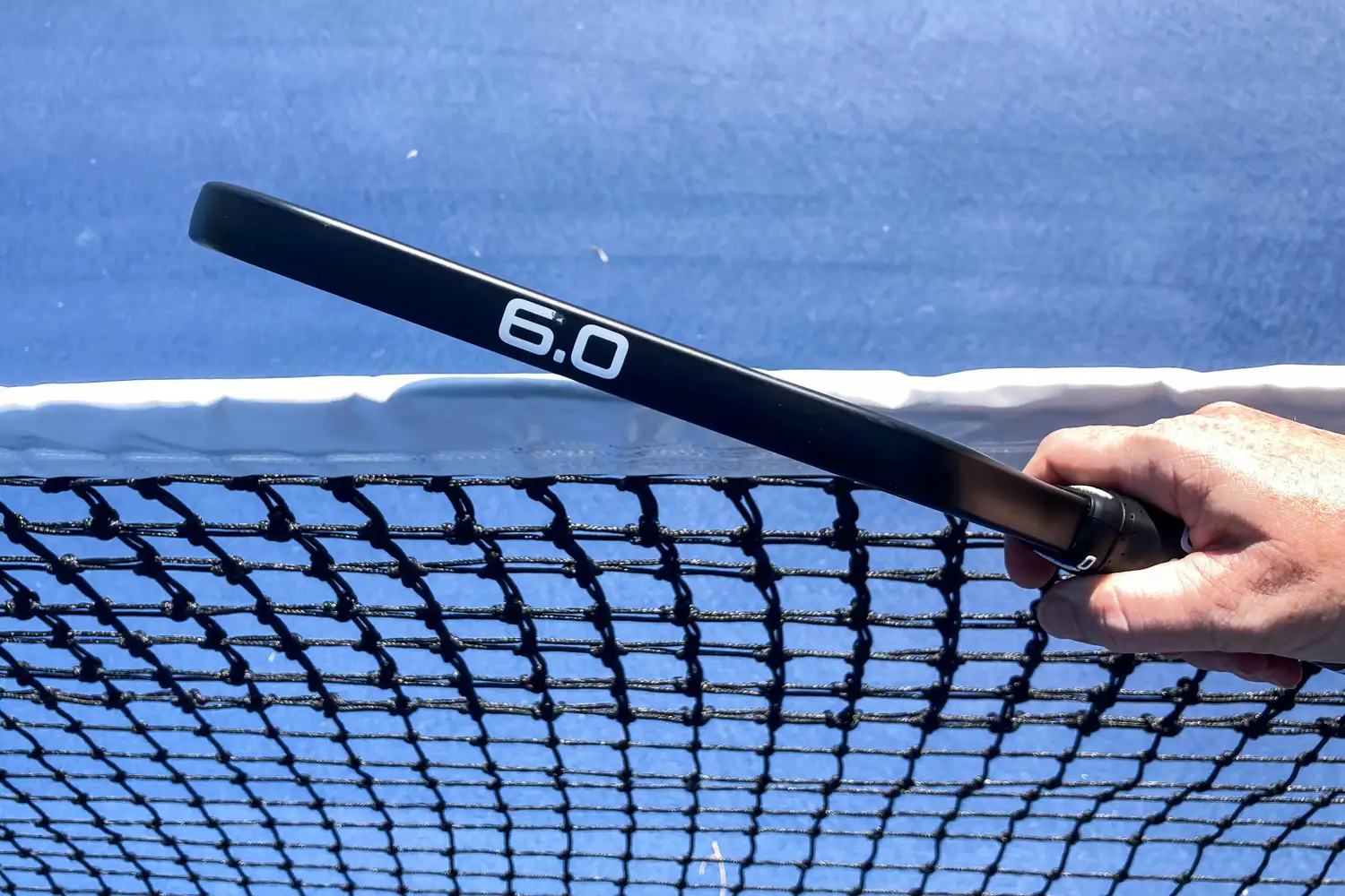 Side view showing the thickness profile of a Six Zero pickleball paddle.
