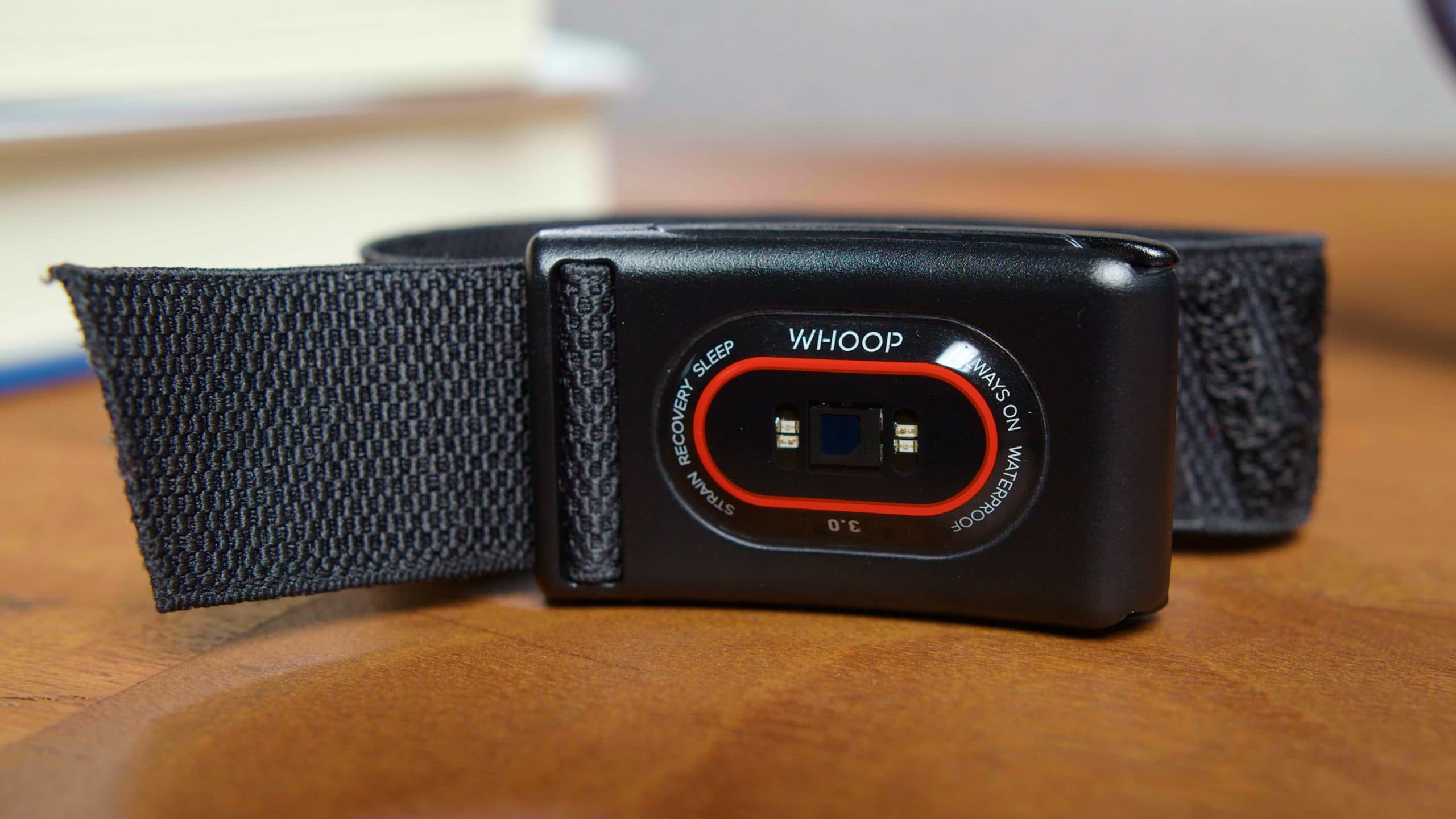 A Whoop wearable fitness tracker showing a minimalist design without a screen.