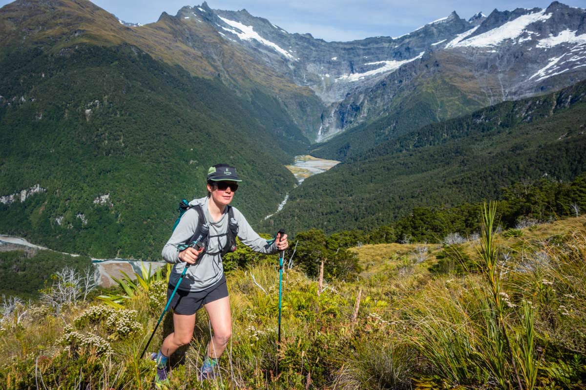 A trail runner wearing a long-sleeved Black Diamond sun hoody in the mountains.