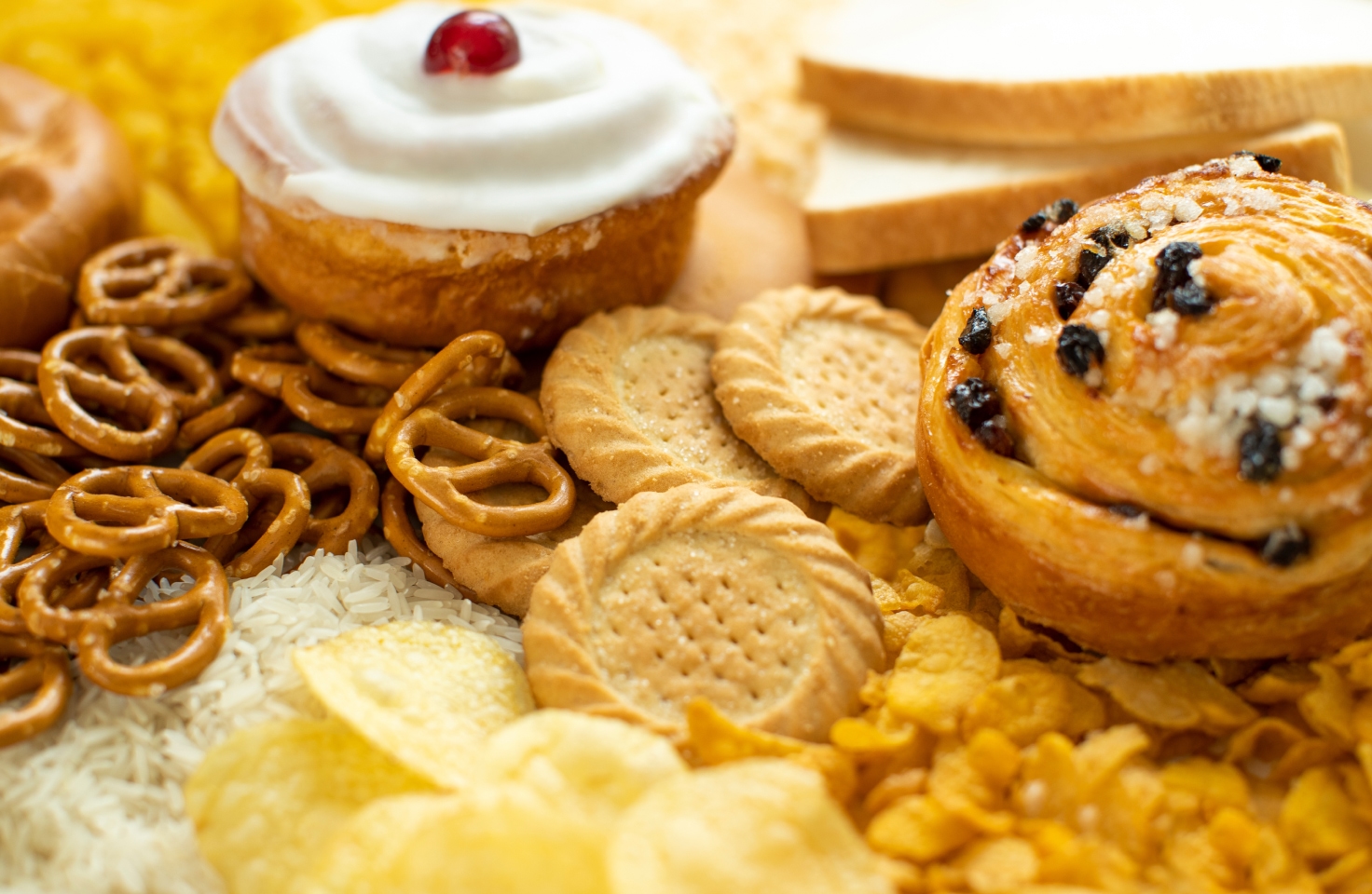 An assortment of healthy foods including whole grains and fruit, representing dietary impact on glucose.