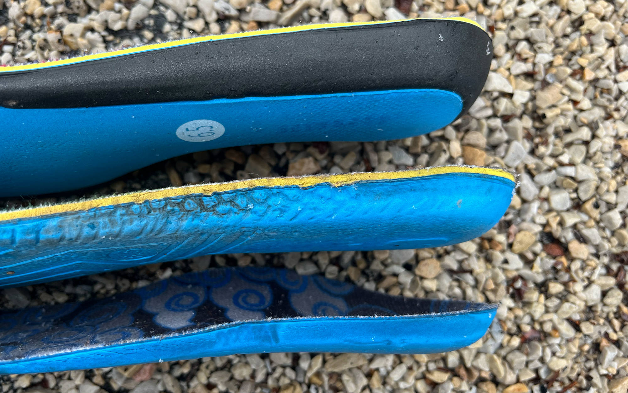 An exploded view diagram showing the multiple material layers of an impact-absorbing insole.