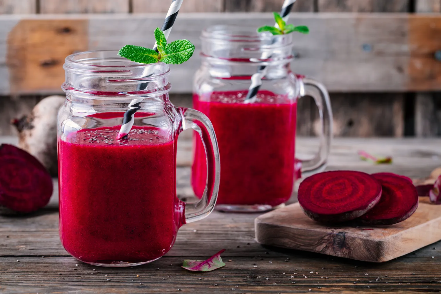 A glass of vibrant beetroot juice garnished with chia seeds.
