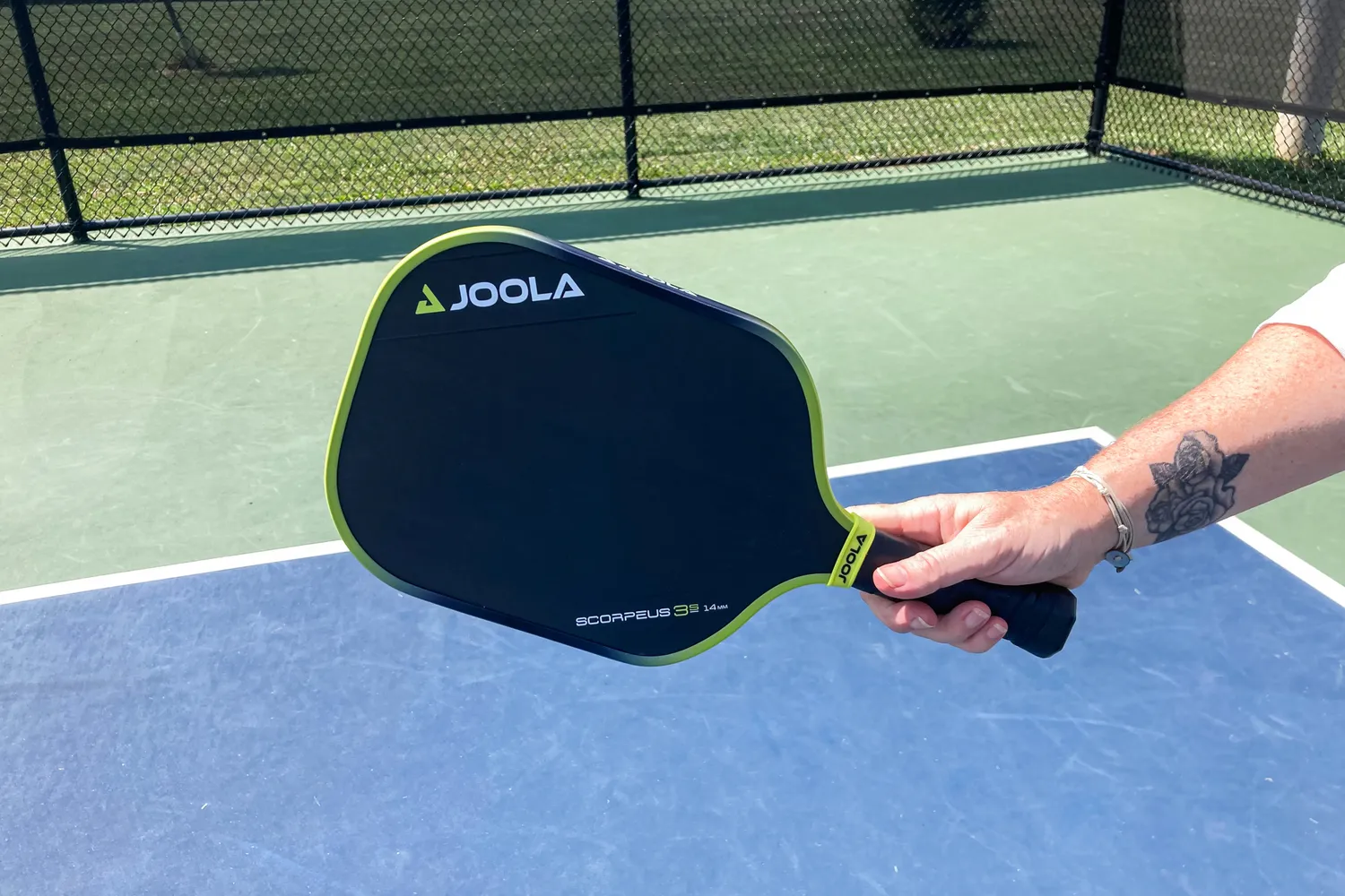 A person holding the JOOLA Anna Bright Scorpeus 3S paddle.