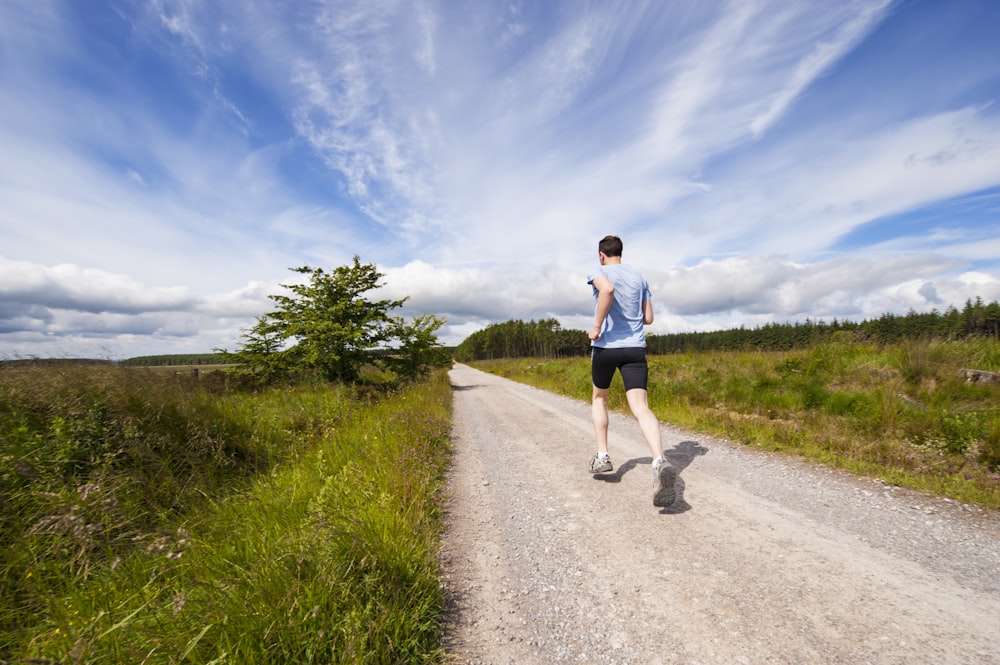 A runner sprinting with effort and determination toward a finish line.