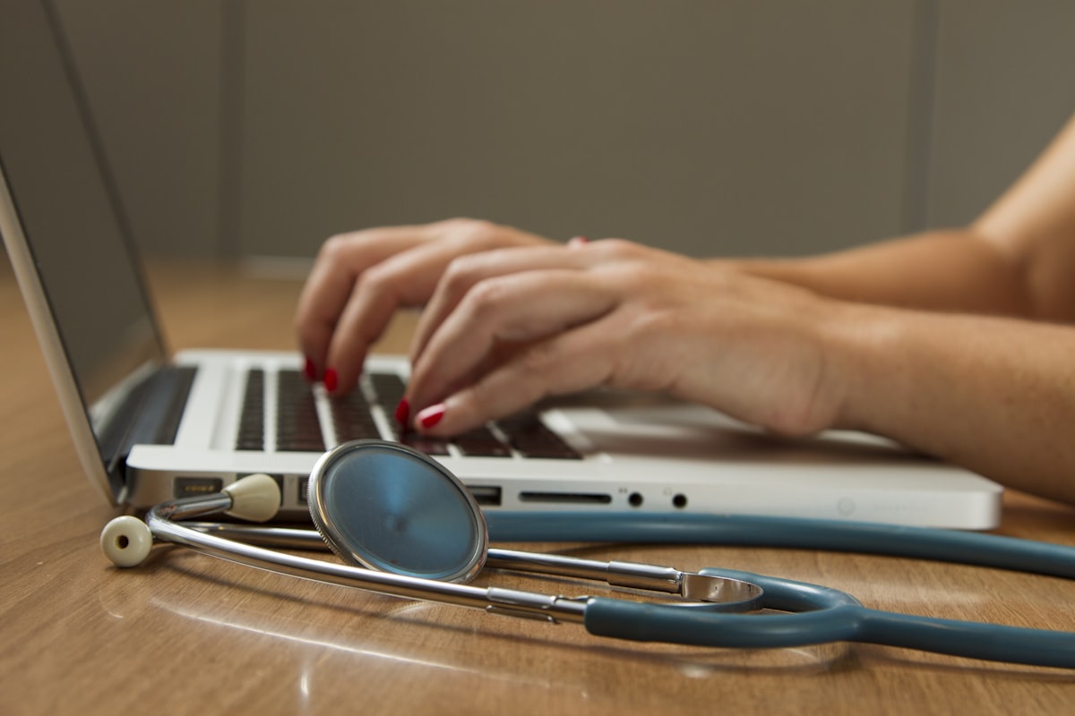 A doctor in a white coat reviewing health data and lab results with a patient.